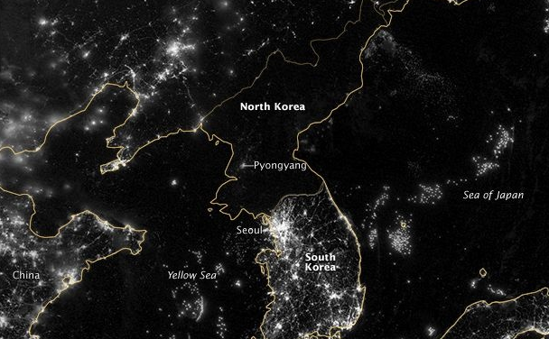 North Korea's barren electrical grid at night compared to South Korea's grid, which teems with lights. 