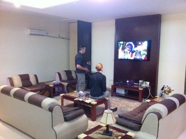 DOD task force employees play Guitar Hero in a luxurious Afghan villa. Photo: Courtesy of War is Boring 