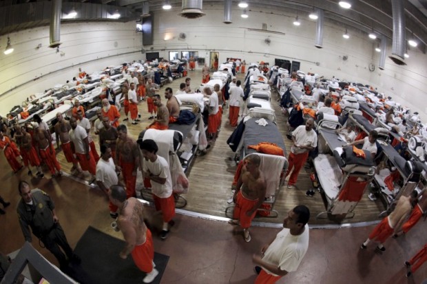File photo of inmates walking around a gymnasium where they are housed due to overcrowding at the California Institution for Men state prison in Chino
