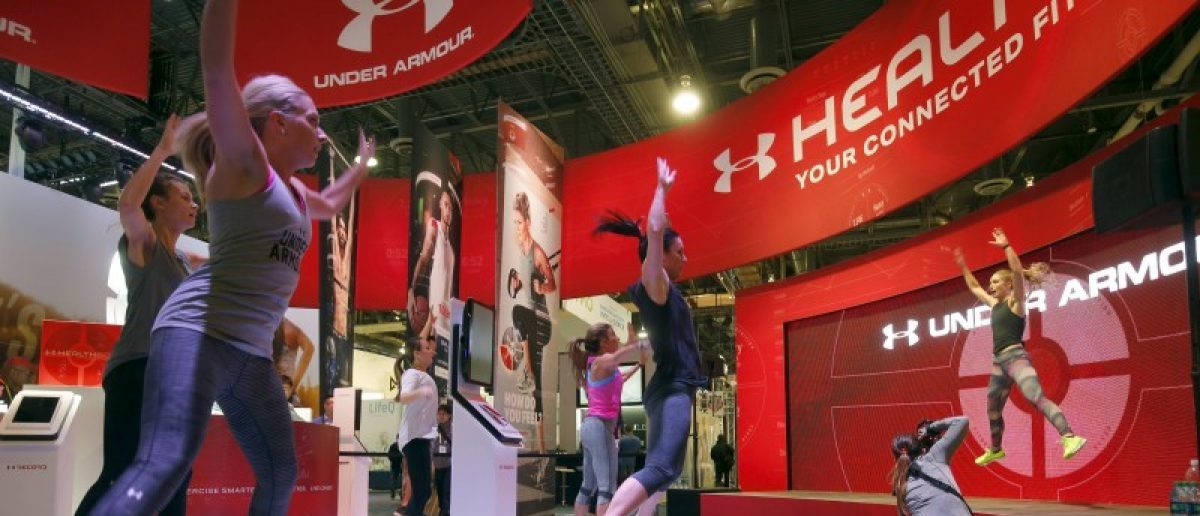 People work out at the Under Armour booth as the company promotes the Health Box, a Connected Fitness system, during the 2016 CES trade show in Las Vegas, Nevada January 8, 2016. REUTERS/Steve Marcus