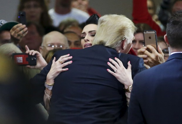 Republican U.S. presidential candidate Donald Trump hugs Miss Wisconsin USA 2005 Melissa Young, during a Town Hall in Janesville, March 29, 2016. REUTERS/Kamil Krzaczynski TPX IMAGES OF THE DAY - RTSCR9B