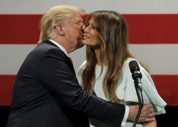 U.S. Republican presidential candidate Donald Trump embraces his wife Melania at a campaign event in Milwaukee, Wisconsin, United States, April 4, 2016. REUTERS/Jim Young