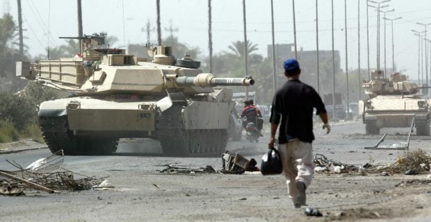 BAGHDAD, Iraq: Soldiers with the U.S. Army 1st Cavalry Division, 1st Brigade, 1-12 Cav. from Fort Hood, Texas, patrol the streets in M1-A1 Abrams tanks and Bradley fighting vehicles in Baghdad's Sadr City slum 18 August 2004. (Photo: DAVID P. GILKEY/AFP/Getty Images)