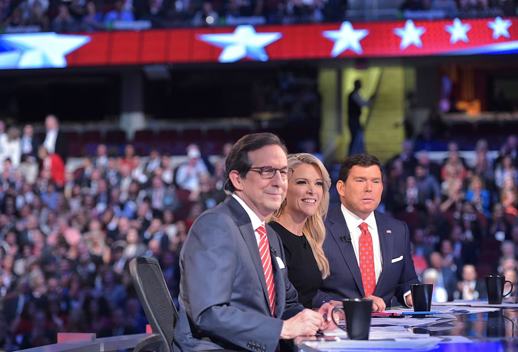 Prime time Republican presidential primary debate moderator Megyn Kelly (C) flanked by fellow moderators Chris Wallace (L) and Bret Baier (R) moments before the candidates arrived on stage at the Quicken Loans Arena in Cleveland, Ohio (Getty Images)