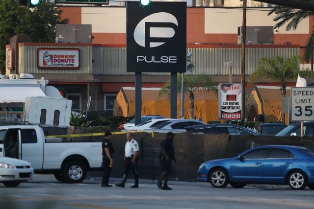 Law enforcement officials investigate near the Pulse nightclub. (Photo: Getty Images)