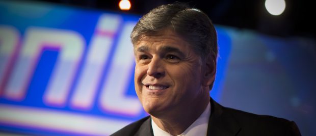 Fox News Channel anchor Sean Hannity poses for photographs as he sits on the set of his show "Hannity" at the Fox News Channel's studios in New York City, October 28, 2014. REUTERS/Mike Segar (UNITED STATES - Tags: MEDIA POLITICS ENTERTAINMENT) - RTR4BYJL