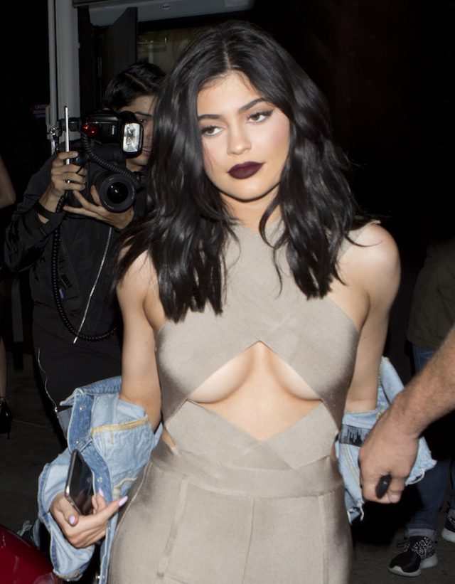 Kylie Jenner wearing a very revealing one piece beige Jump Suit was seen le...