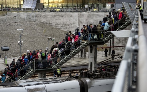 Police organize a line of refugees on a stairway leading up to trains arriving from Denmark at the Hyllie train station outside Malmo, Sweden, November 19, 2015. REUTERS/Johan Nilsson/TT News Agency