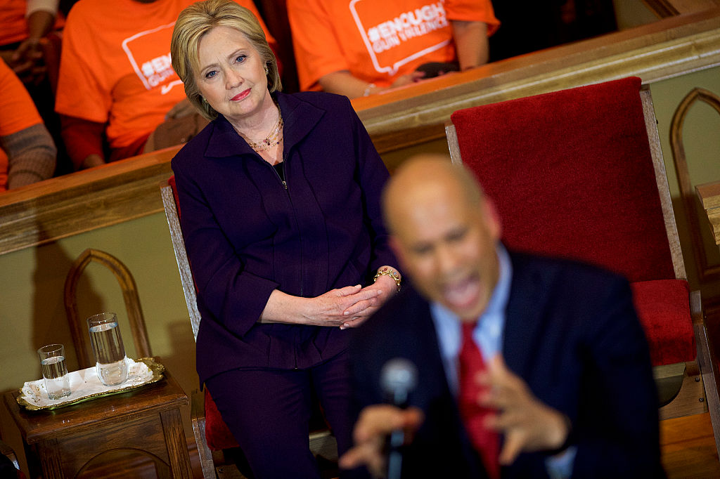 Hillary Clinton listens to Sen. Cory Booker (D-NJ) during a Breaking Down Barriers Town Hall (Getty Images)