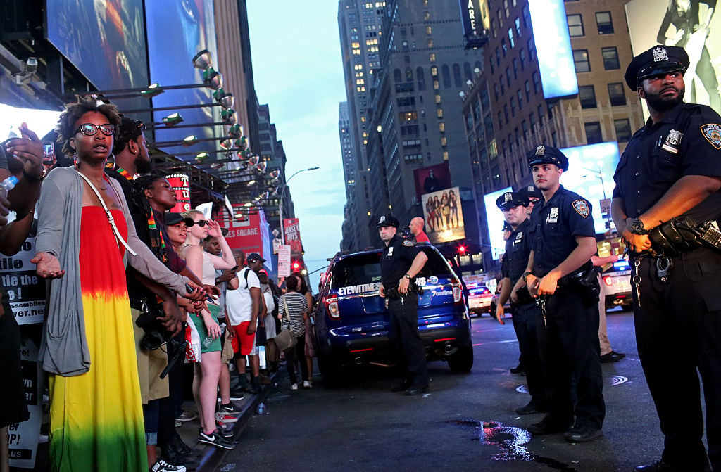 Activists protest in Times Square in response to the recent fatal shootings of two black men by police (Getty Images)