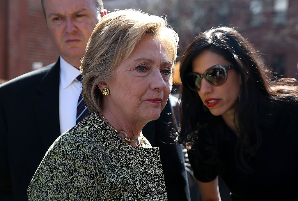 Hillary Clinton (L) talks with aide Huma Abedin (R) before speaking at a neighborhood block party on April 17, 2016 (Getty Images)