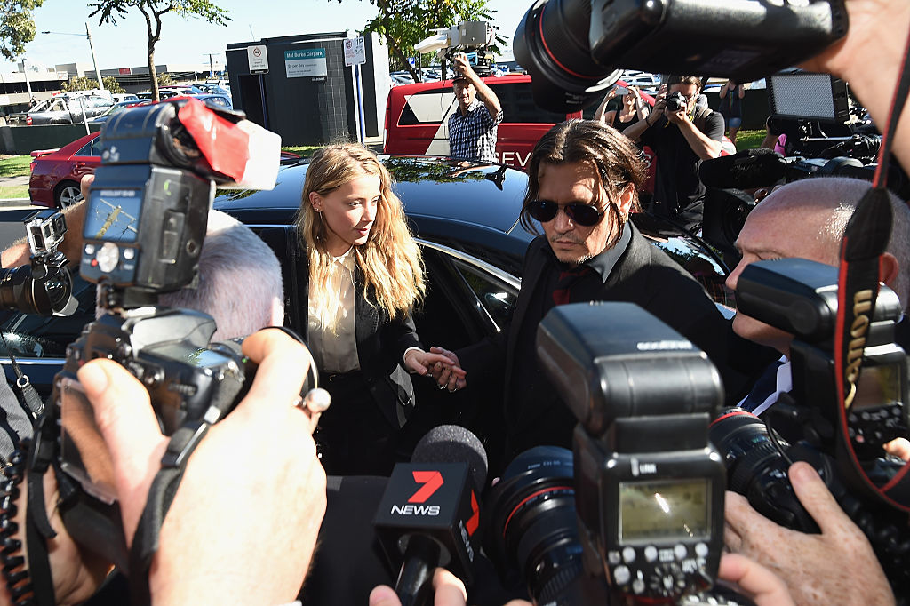 Depp and Heard exit a car surrounded by paparazzi. (Photo by Matt Roberts/Getty Images)