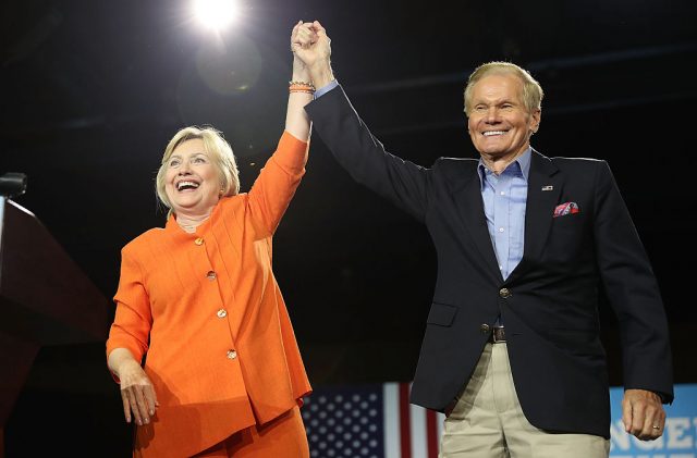 Hillary Clinton stands with Sen. Bill Nelson (D-FL) as she attends a campaign rally at the Exhibition Hall in Kissimmee, Florida (Getty Images)