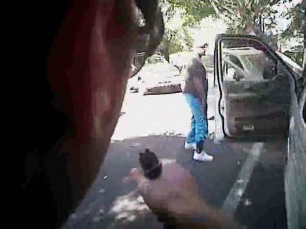 Keith Scott looks over to police with hands by his sides just before he was shot four times by Charlotte police in Charlotte