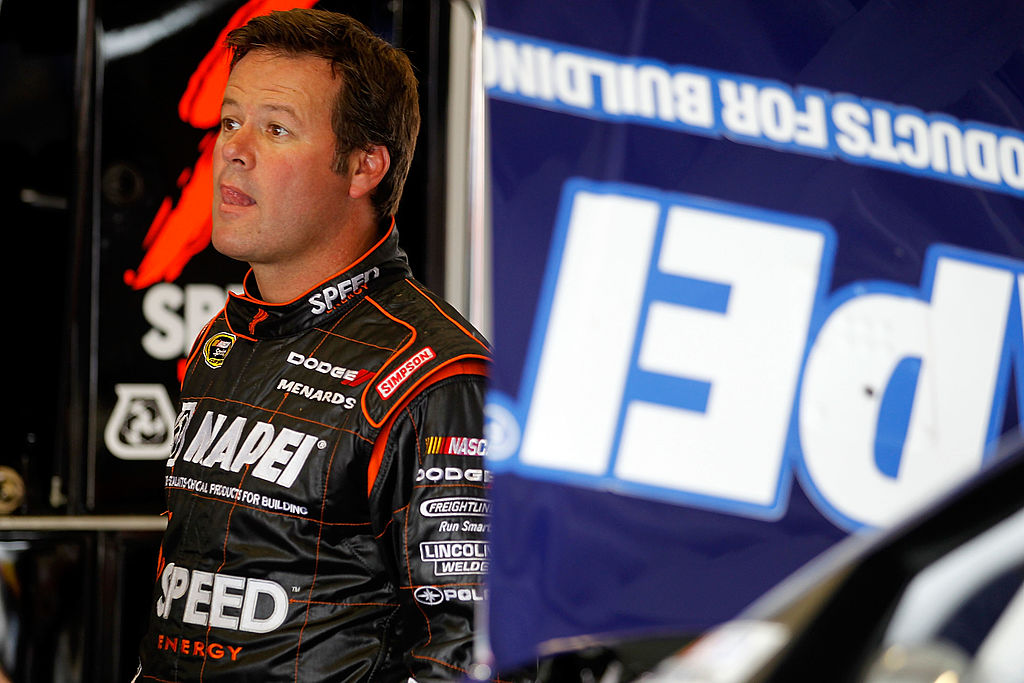 DAYTONA BEACH, FL - FEBRUARY 22: Robby Gordon, driver of the #7 Mapei/Menards/Speed Energy Dodge, stands in the garage during practice for the NASCAR Sprint Cup Series Daytona 500 at Daytona International Speedway on February 22, 2012 in Daytona Beach, Florida. (Photo by Todd Warshaw/Getty Images for NASCAR)