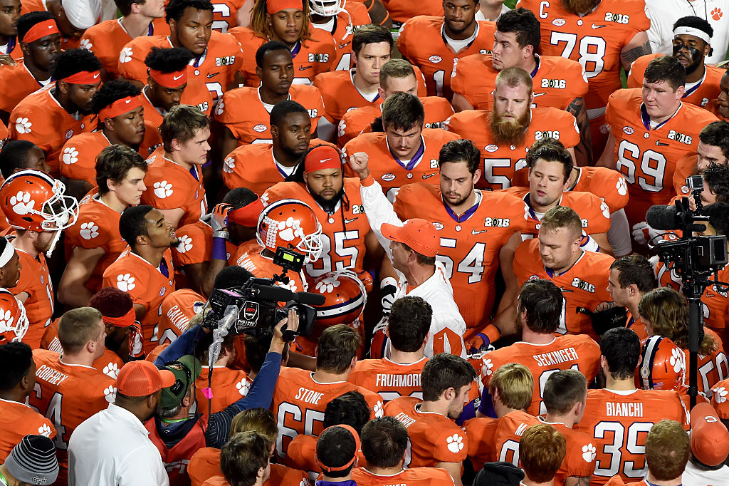 GLENDALE, AZ - JANUARY 11: Head coach Dabo Swinney of the Clemson Tigers huddles up with his team before taking on the Alabama Crimson Tide in the 2016 College Football Playoff National Championship Game at University of Phoenix Stadium on January 11, 2016 in Glendale, Arizona. (Photo by Norm Hall/Getty Images)