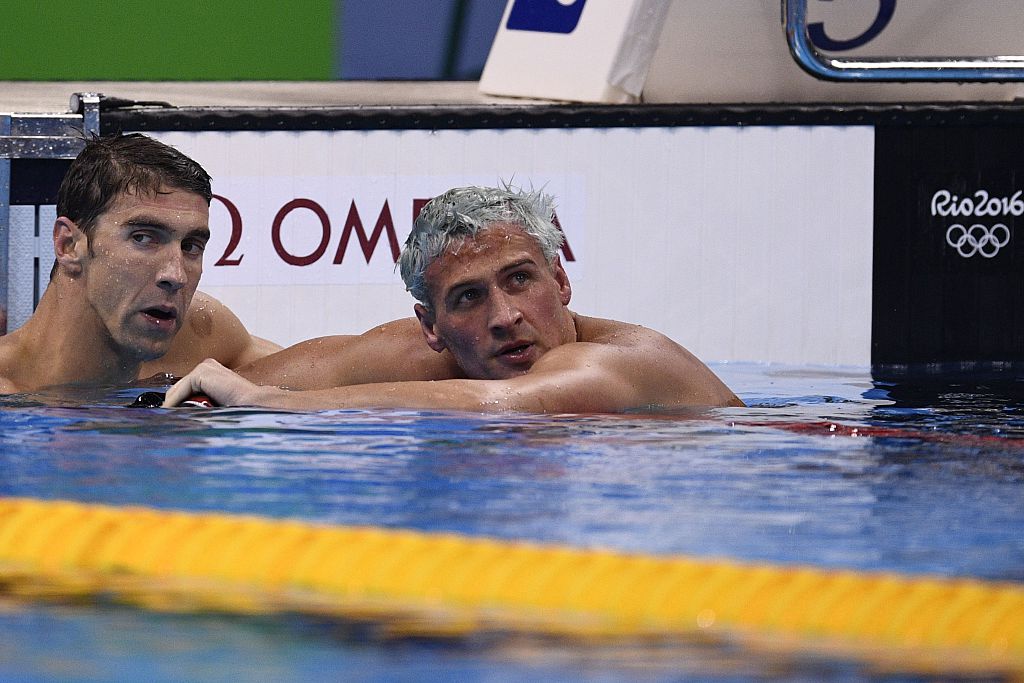 USA's Ryan Lochte (R) looks dejected next to USA's Michael Phelps after they competed in the Men's 200m Individual Medley Final during the swimming event at the Rio 2016 Olympic Games at the Olympic Aquatics Stadium in Rio de Janeiro on August 11, 2016. / AFP / Martin BUREAU (Photo credit should read MARTIN BUREAU/AFP/Getty Images)