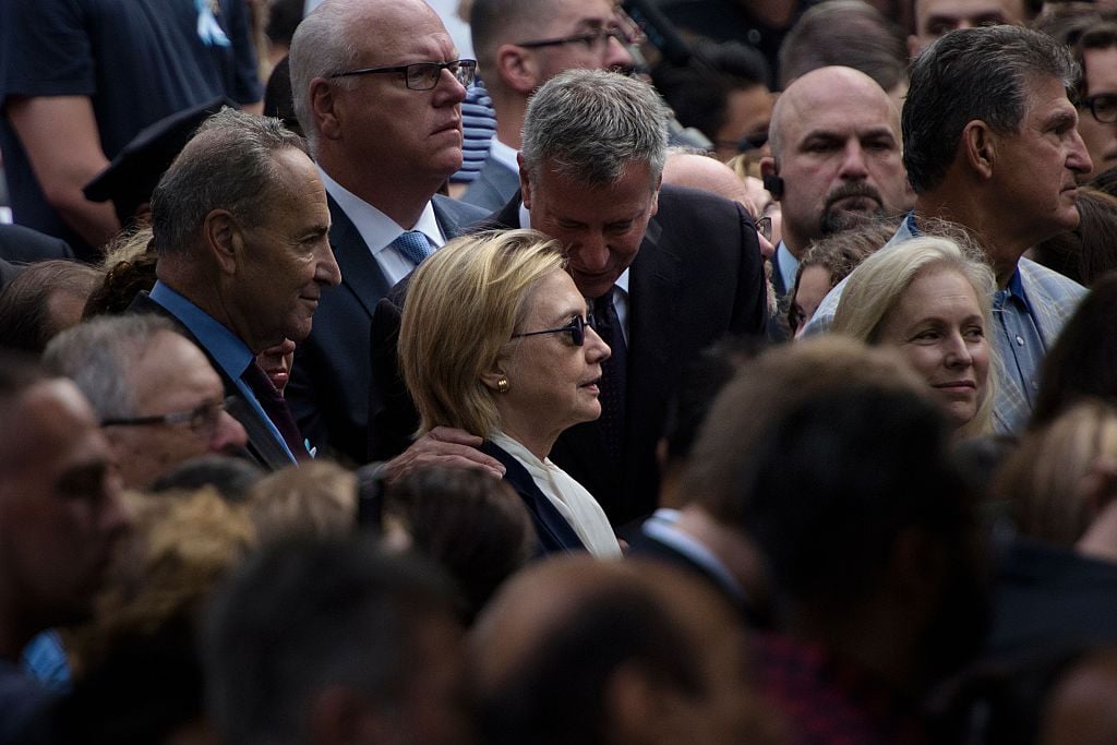 New York City Mayor Bill de Blasio speaks to US Democratic presidential nominee Hillary Clinton during a memorial service at the National 9/11 Memorial September 11, 2016 in New York (Getty Images)