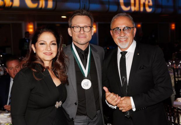 NEW YORK, NY - SEPTEMBER 12: Gloria Estefan, Christian Slater and Emilio Estefan attend the 31th Annual Great Sports Legends Dinner to benefit The Buoniconti Fund to Cure Paralysis at The Waldorf Astoria Hotel on September 12, 2016 in New York City. (Photo by Thos Robinson/Getty Images for The Buoniconti Fund)