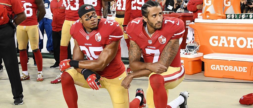 Colin Kaepernick #7 and Eric Reid #35 of the San Francisco 49ers kneel in protest during the national anthem prior to playing the Los Angeles Rams in their NFL game at Levi's Stadium on September 12, 2016 in Santa Clara, California