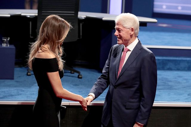 Republican presidential nominee Donald Trump's wife, Melania Trump greets with Democratic presidential nominee Hillary Clinton's husband and former U.S. President Bill Clinton during the Presidential Debate at Hofstra University on September 26, 2016 in Hempstead, New York