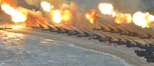 Artillery pieces are seen being fired during a military drill at an unknown location, in this undated photo released by North Korea's Korean Central News Agency (KCNA) on March 25, 2016. REUTERS/KCNA/File