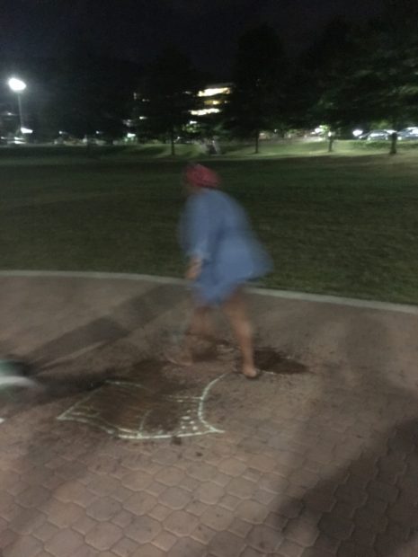 A person at Appalachian State walking over a drawing of the American flag. [Anonymous Appalachian State student]