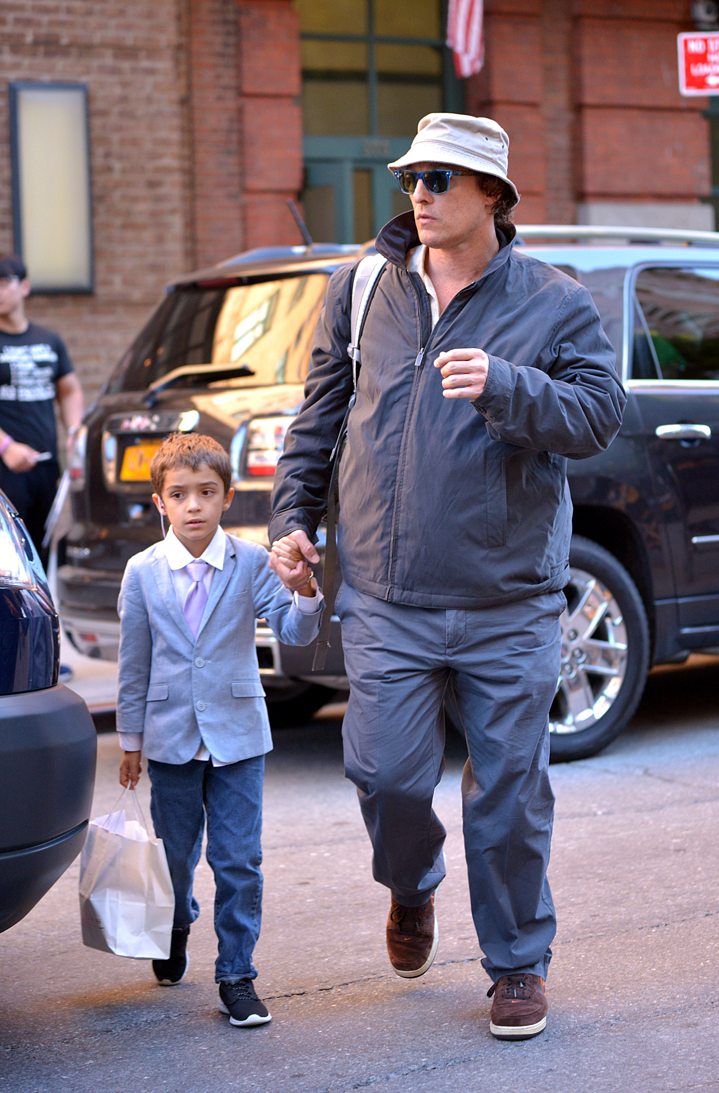 Here he is leaving a NYC hotel with his son. (Photo credit: Splash News)