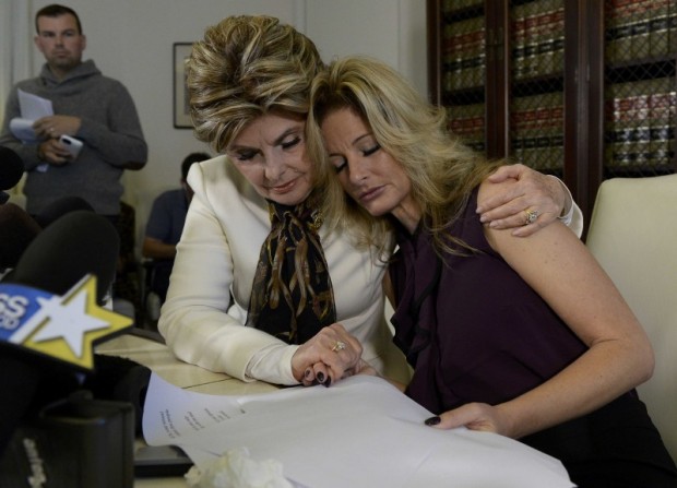 Summer Zervos, a former contestant on the TV show The Apprentice, is embraced by lawyer Gloria Allred (L) while speaking about allegations of sexual misconduct against Donald Trump during a news conference in Los Angeles, California, U.S. October 14, 2016. REUTERS/Kevork Djansezian TPX IMAGES OF THE DAY