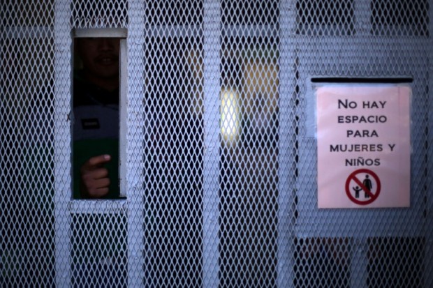 A Haitian migrant is seen at La casa del Migrante shelter aafter leaving Brazil, where they sought refuge after Haiti's 2010 earthquake, but are now attempting to enter the U.S., in Tijuana, Mexico, October 3, 2016. The sign reads, "There is no room for women and children". Picture taken October 3, 2016. REUTERS/Edgard Garrido