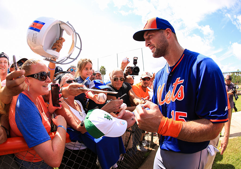 Tebow signs autographs for fans at Instructional League play (Photo credit: Getty Images)