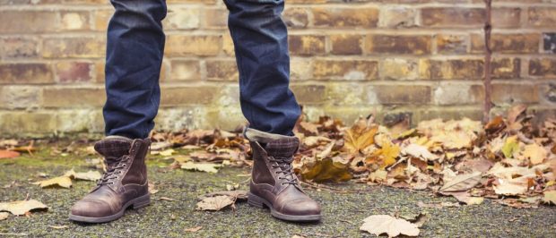A man wears high ankle boots during autumn (Photo via Shutterstock)