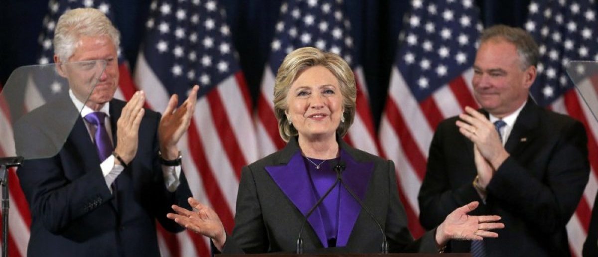 Democratic presidential candidate Hillary Clinton, with her husband, former U.S. President Bill Clinton, (L), and her Vice-President running mate Tim Kaiine (R), applaud at her concession speech to President-elect Donald Trump in New York, U.S., November 9, 2016. REUTERS/Carlos Barria