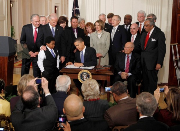 U.S. President Barack Obama signs the Affordable Care Act, dubbed Obamacare, the comprehensive healthcare reform legislation during a ceremony in the East Room of the White House in Washington, U.S., March 23, 2010. REUTERS/Jason Reed/File Photo