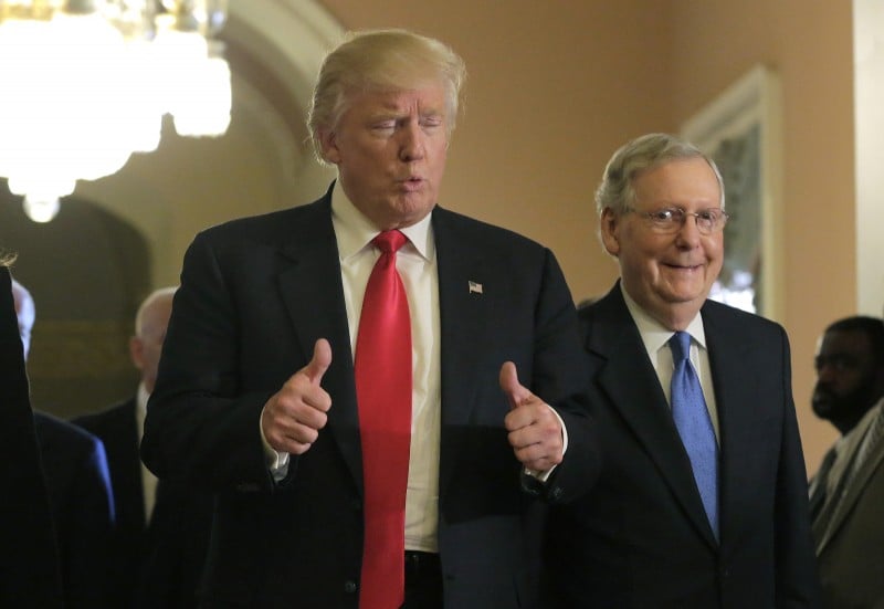 Donald Trump gives a thumbs up sign as he walks with Senate Majority Leader Mitch McConnell on Capitol Hill (Reuters Pictures)