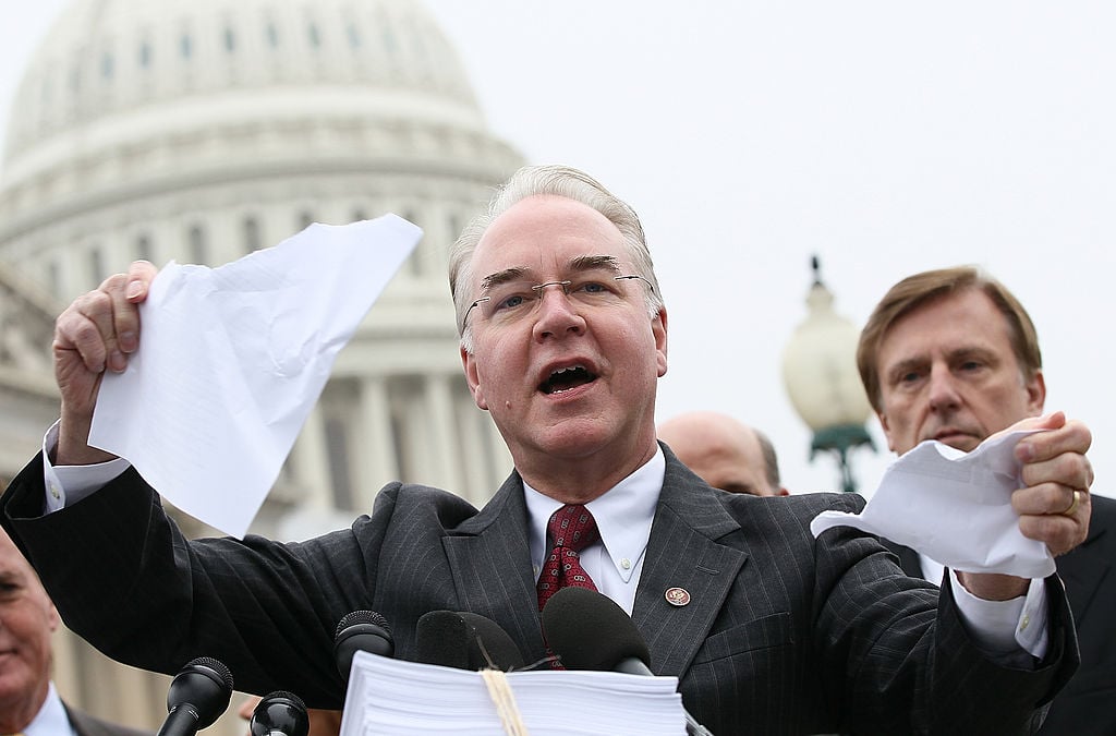 Tom Price tears a page from the national health care bill during a press conference at the U.S. Capitol on March 21, 2012 (Getty Images)