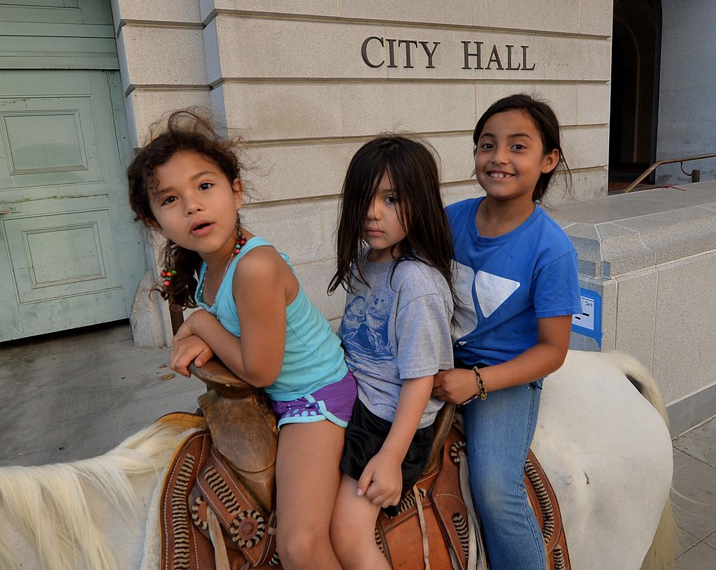 Immigrant children protesters ride a horse past City Hall during their march through the streets of Los Angeles (Getty Images)