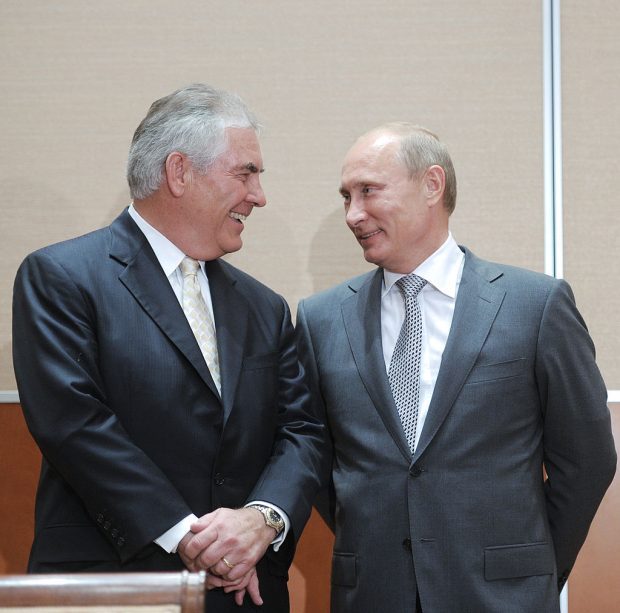 Russia's Prime Minister Vladimir Putin (L) speaks with ExxonMobil President and Chief Executive Officer Rex Tillerson during the signing of a Rosneft-ExxonMobil strategic partnership agreement in Sochi on August 30, 2011. Russia's oil champion Rosneft and US ExxonMobil clinched a global deal worth up to half-a-trillion dollars that will see the US supermajor take BP's place in pioneering Arctic exploration work. AFP PHOTO / RIA NOVOSTI / POOL / ALEXEY DRUZHININ (Photo credit should read ALEXEY DRUZHININ/AFP/Getty Images)