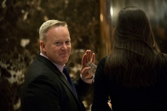 Sean Spicer waves to reporters at Trump Tower (Getty Images)