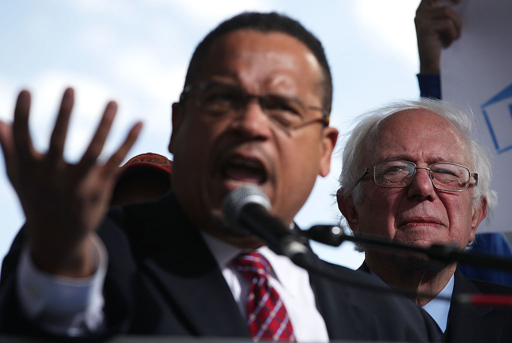 Bernie Sanders looks on as Keith Ellison speaks during a rally on jobs on December 7, 2016 (Getty Images)