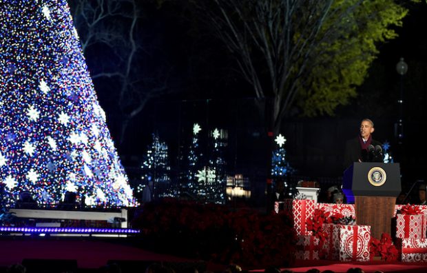 U.S. President Barack Obama, surrounded by Christmas gifts, makes remarks at the 94th Annual National Christmas Tree Lighting ceremony on The Ellipse, near the White House, in Washington, U.S., December 1, 2016. REUTERS/Mike Theiler - RTSUA4B