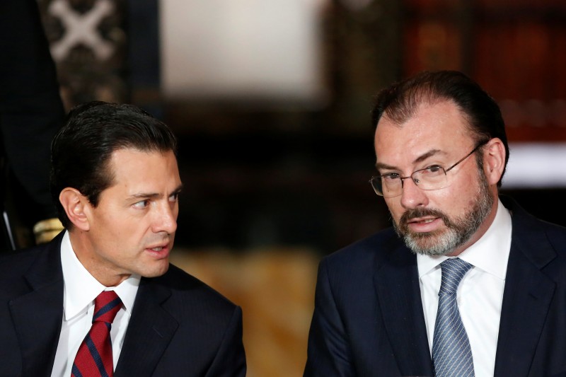Mexico's President Enrique Pena Nieto chat with Mexico's Foreign Minister Luis Videgaray during a meeting with members of the diplomatic corps in Mexico City, Mexico