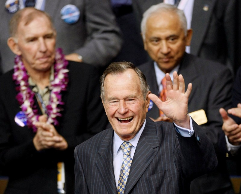 Former U.S. President George H.W. Bush waves as he enters the second session of the 2008 Republican National Convention in St. Paul, Minnesota in this September 2, 2008 file photograph. REUTERS/Rick Wilking/File Photo