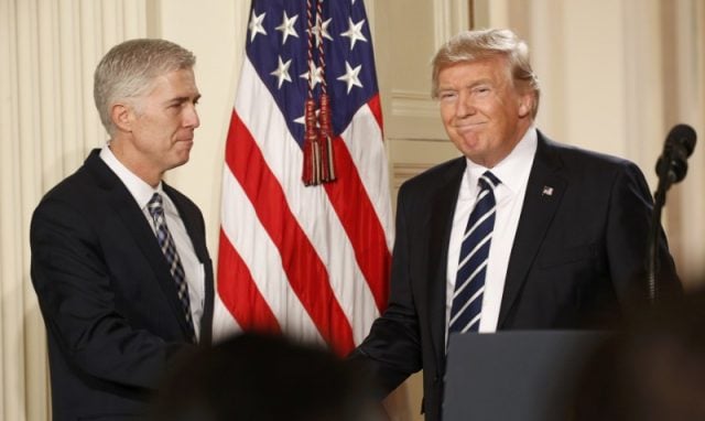 U.S. President Donald Trump shakes hands with Neil Gorsuch (L) after nominating him to be an associate justice of the U.S. Supreme Court at the White House in Washington, D.C., U.S., January 31, 2017. REUTERS/Kevin Lamarque
