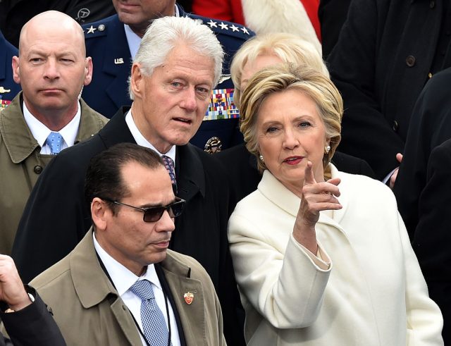 Former President Bill Clinton and Hillary Clinton on the platform before the swearing in ceremony for Donald Trump at the US Capitol January 20, 2017 in Washington, D.C. (Photo credit: PAUL J. RICHARDS/AFP/Getty Images)