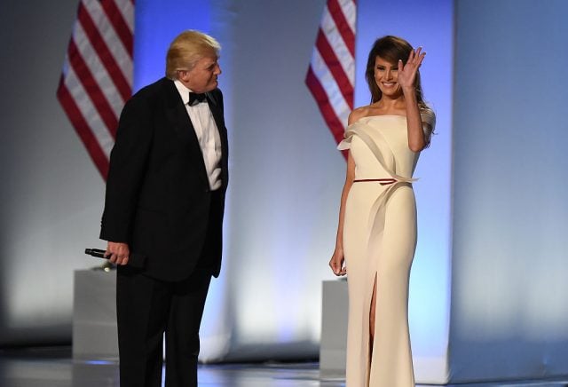 US President Donald Trump and First Lady Melania Trump take the stage at the Freedom Inaugural Ball, January 20, 2017, in Washington, DC. / AFP / Robyn Beck (Photo credit should read ROBYN BECK/AFP/Getty Images)