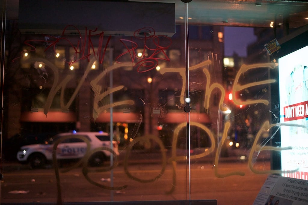 Slogans spray painted on a metro bus shelter – Daily Caller – Abbey Jaroma