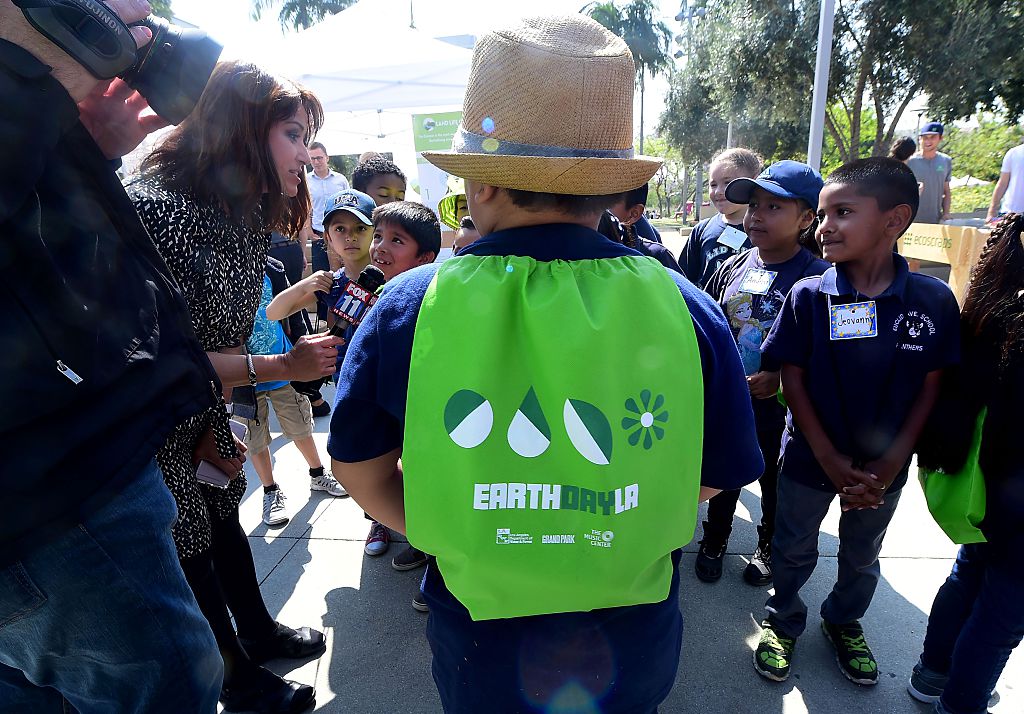 Children are interviewed by news media as elementary schoolchildren attend the Grand Park Earth Day celebration in downtown Los Angeles, California on April 22, 2016. Founded in 1970 as a day of education about environmental issues, Earth Day is now globally celebrated. FREDERIC J. BROWN/AFP/Getty Images