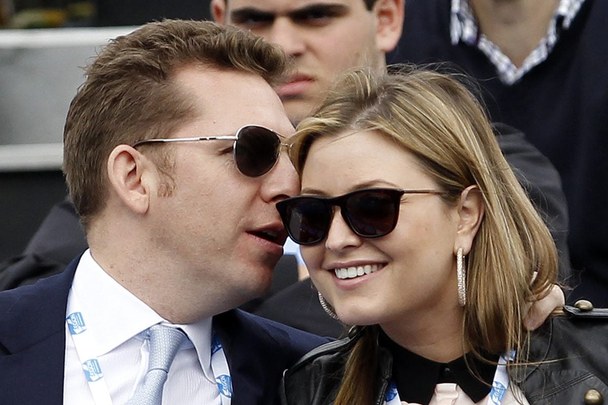 Property tycoon Nick Candy whispers into the ear of his wife, actress Holly Valance. [REUTERS/Stefan Wermuth]
