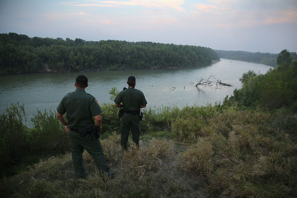 MISSION, TX - JULY 24: U.S. Border Patrol agents look for immigrants crossing the Rio Grande from Mexico (L), to the United States at dusk on July 24, 2014 near Mission, Texas. Tens of thousands of undocumented immigrants, many of them families or unaccompanied minors, have crossed illegally into the United States this year and presented themselves to federal agents, causing a humanitarian crisis on the U.S.-Mexico border. Texas' Rio Grande Valley has become the epicenter of the latest immigrant crisis, as more immigrants, especially Central Americans, cross illegally from Mexico into that sector than any other stretch of the America's 1,933 mile border with Mexico. (Photo by John Moore/Getty Images)